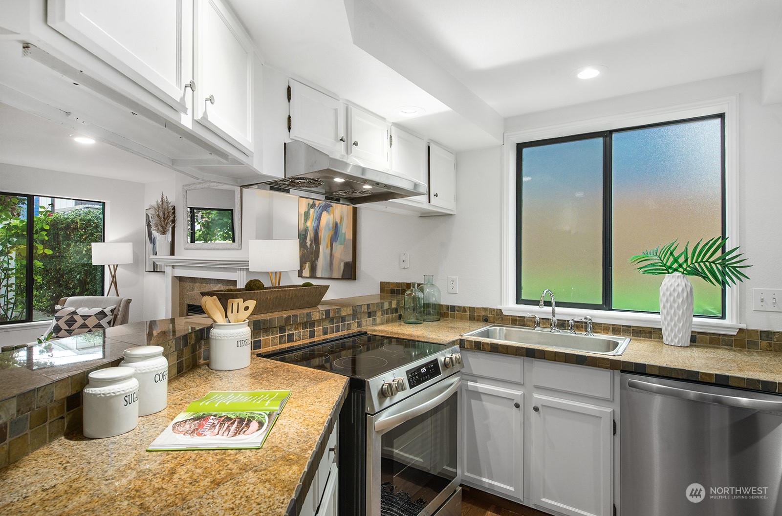 3030 63rd Avenue Southwest, Unit 2 Seattle, WA 98116 - Photo 13 of 32 a kitchen with a sink and a stove top oven