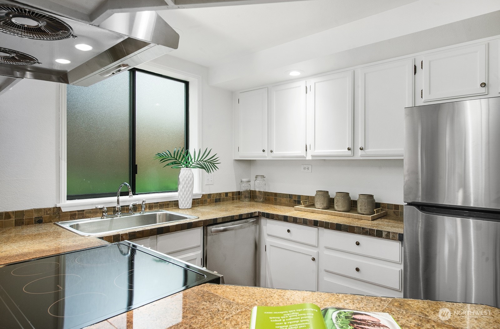 3030 63rd Avenue Southwest, Unit 2 Seattle, WA 98116 - Photo 15 of 32 a kitchen with a sink and cabinets