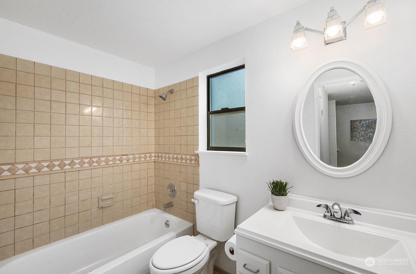 3030 63rd Avenue Southwest, Unit 2 Seattle, WA 98116 - Photo 17 of 32 a bathroom with a toilet a sink a mirror and bathtub