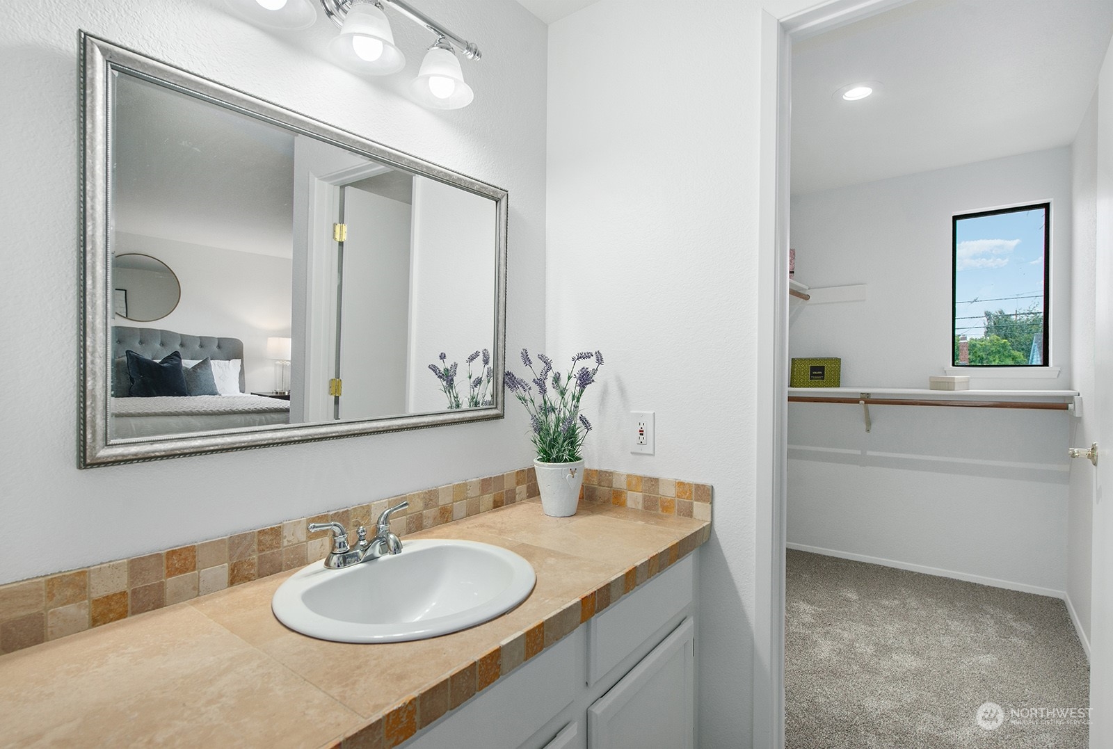 3030 63rd Avenue Southwest, Unit 2 Seattle, WA 98116 - Photo 23 of 32 a bathroom with a granite countertop sink and a mirror