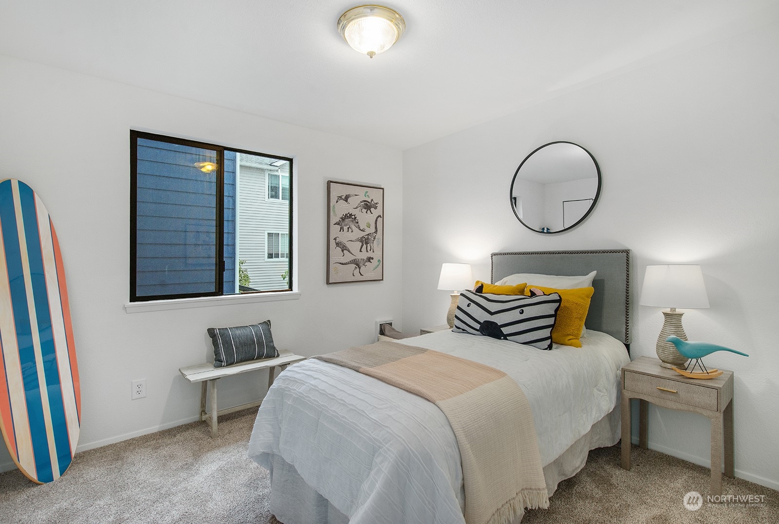 3030 63rd Avenue Southwest, Unit 2 Seattle, WA 98116 - Photo 25 of 32 a bedroom with bed and a chandelier