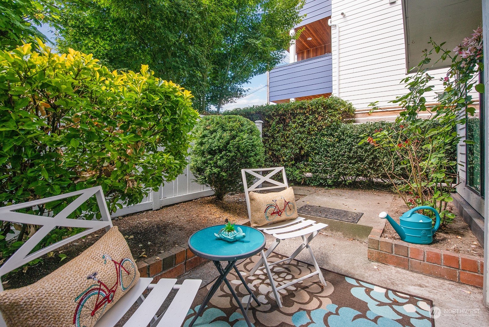 3030 63rd Avenue Southwest, Unit 2 Seattle, WA 98116 - Photo 26 of 32 a backyard of a house with outdoor seating