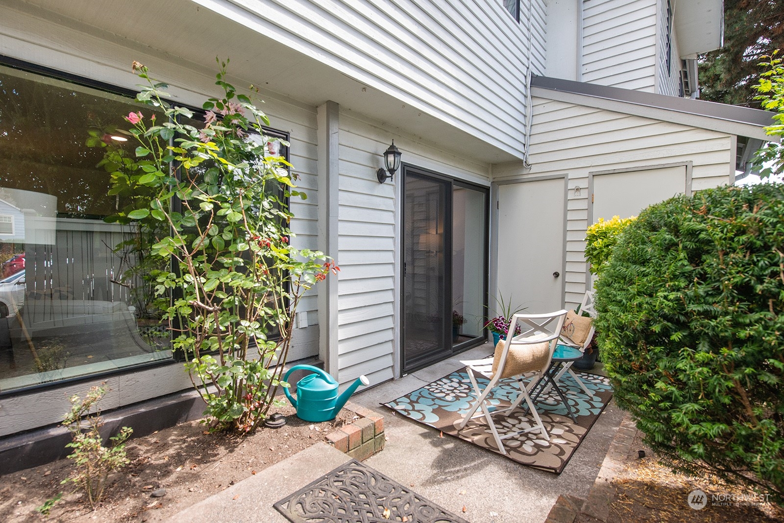 3030 63rd Avenue Southwest, Unit 2 Seattle, WA 98116 - Photo 27 of 32 a view of a porch with chairs and potted plants