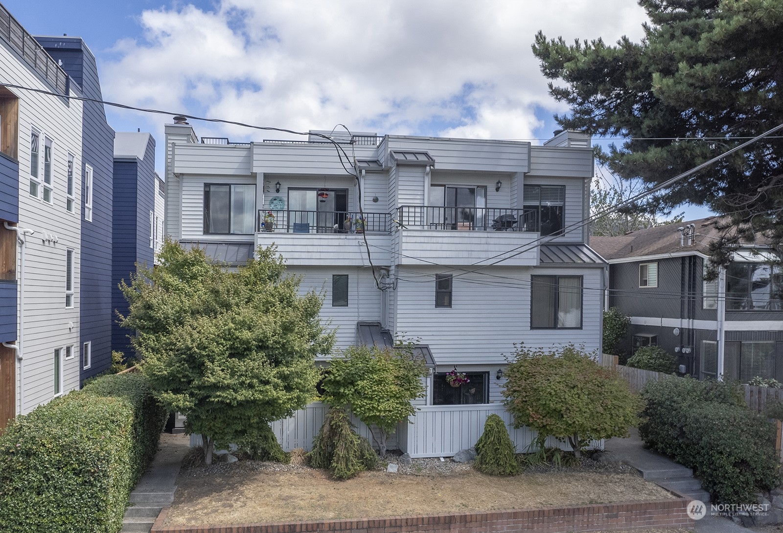 3030 63rd Avenue Southwest, Unit 2 Seattle, WA 98116 - Photo 29 of 32 a view of a white building among the street side