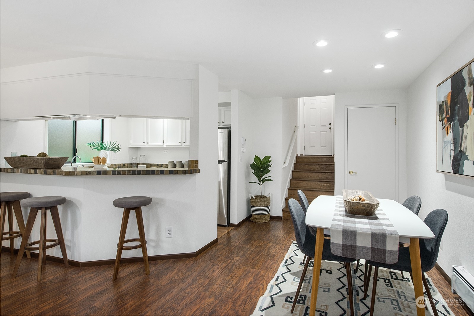 3030 63rd Avenue Southwest, Unit 2 Seattle, WA 98116 - Photo 10 of 32 a kitchen with granite countertop white cabinets and stainless steel appliances