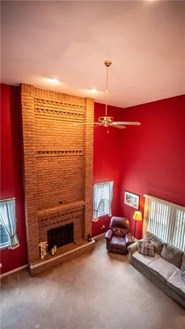 a view of a room with a fireplace and a floor to ceiling window