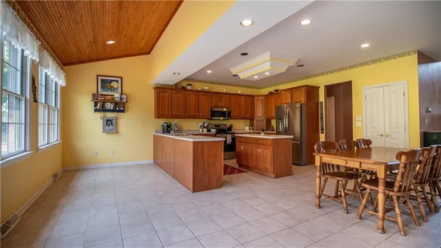 a kitchen with stainless steel appliances granite countertop a sink refrigerator and microwave