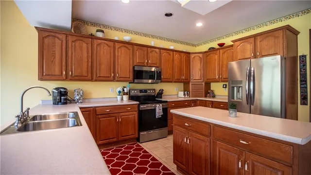 a kitchen with sink refrigerator and cabinets