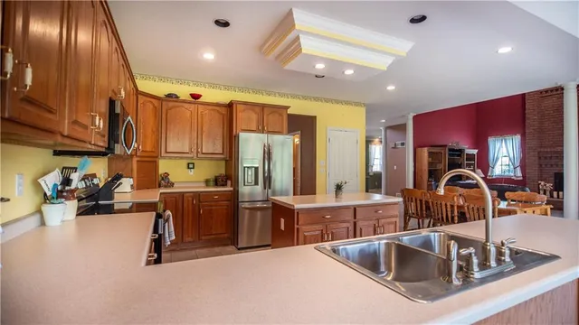 a large kitchen with kitchen island granite countertop a large window