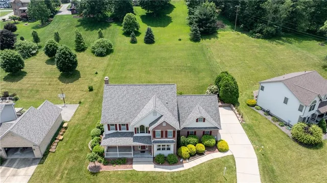 an aerial view of a house with a garden potted plants and large tree