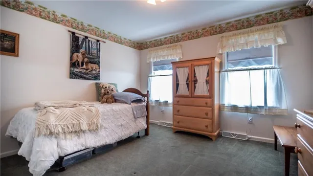 a bedroom with bed and a chandelier