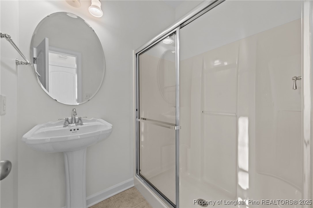 4518 Paces Ferry Drive Durham, NC 27712 - Photo 25 of 44 a bathroom with a sink a mirror and shower