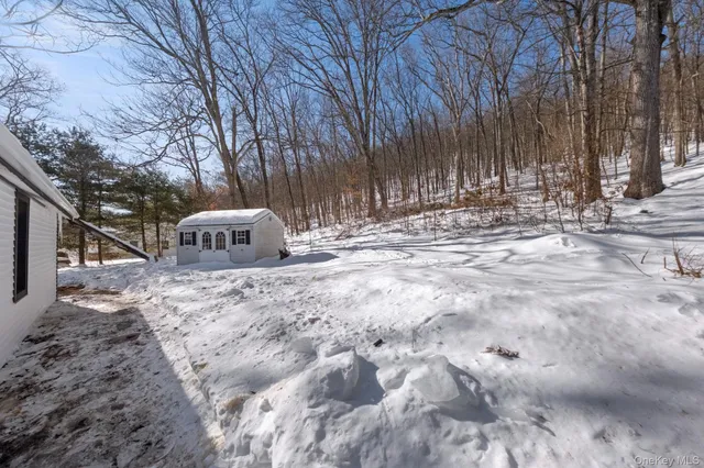 a view of a house with a yard covered with snow