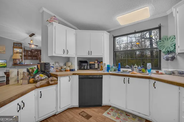 a kitchen with a sink and cabinets