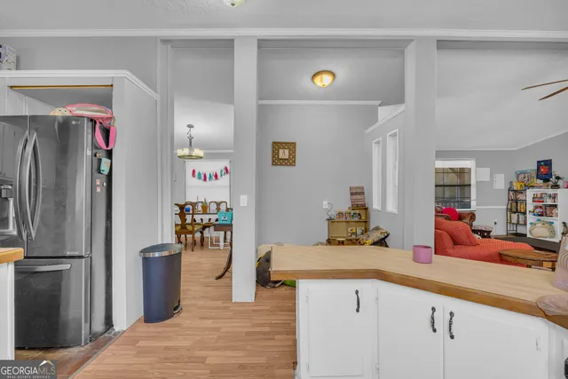 a kitchen with stainless steel appliances granite countertop a refrigerator and a sink