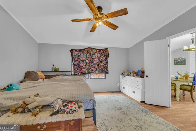 a bedroom with a bed and a dresser in it