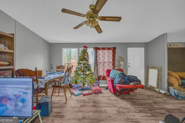 a living room with furniture and a flat screen tv