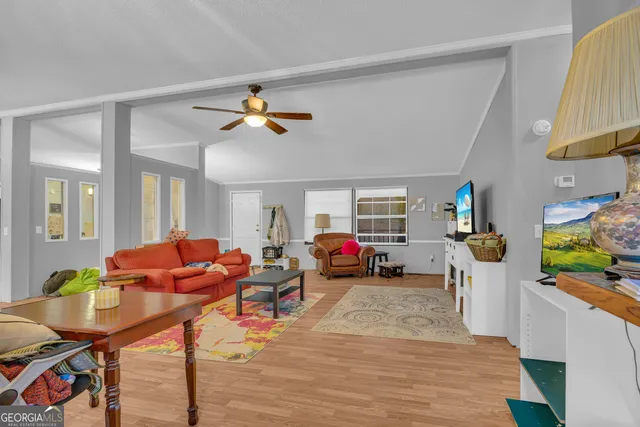 a living room with furniture a rug and a chandelier