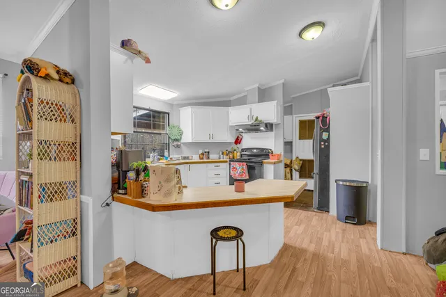 a view of kitchen island with furniture and wooden floor