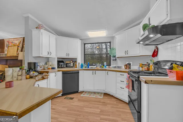 a kitchen with a sink cabinets and window