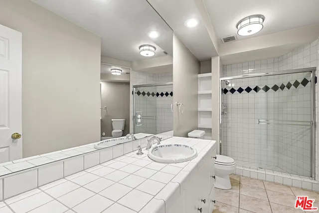 a bathroom with a sink vanity granite and toilet