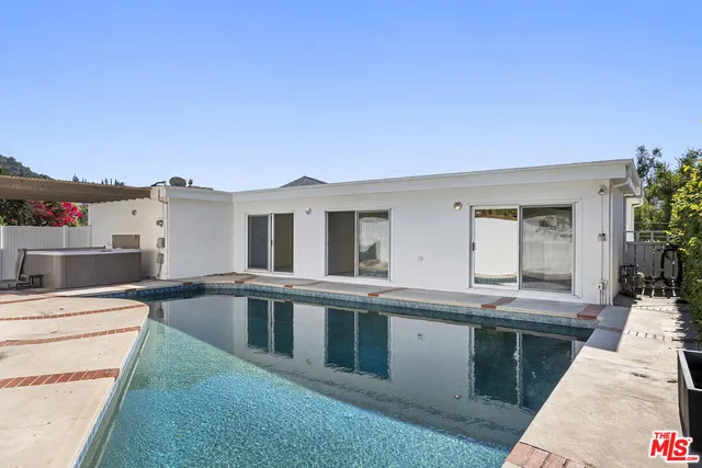 a view of kitchen with granite countertop cabinets and white appliances
