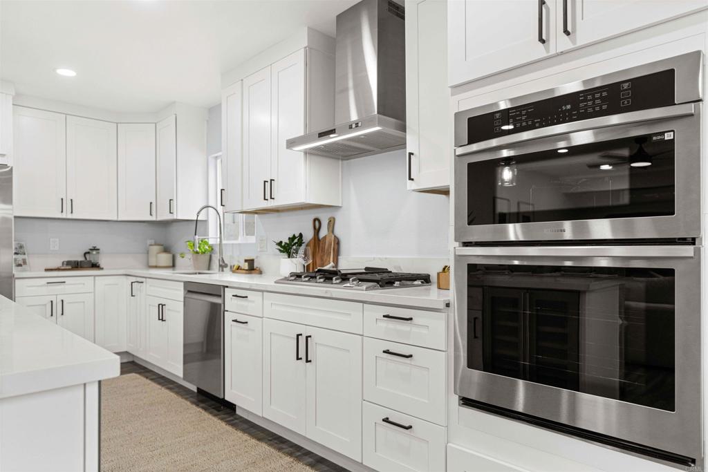 4542 Palm Avenue La Mesa, CA 91941 - Photo 11 of 55 a kitchen with cabinets stainless steel appliances and a wooden floor