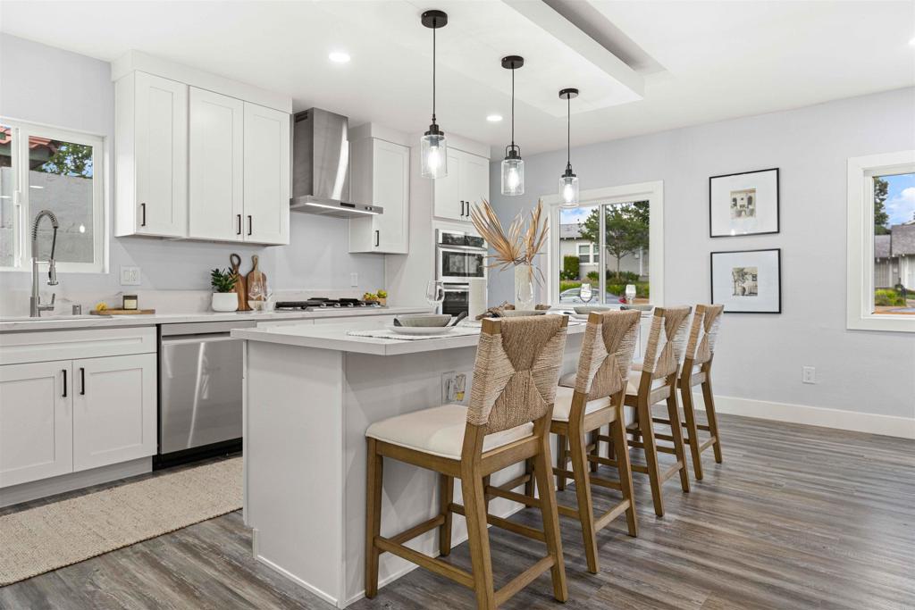 4542 Palm Avenue La Mesa, CA 91941 - Photo 13 of 55 a kitchen with a table chairs refrigerator and cabinets