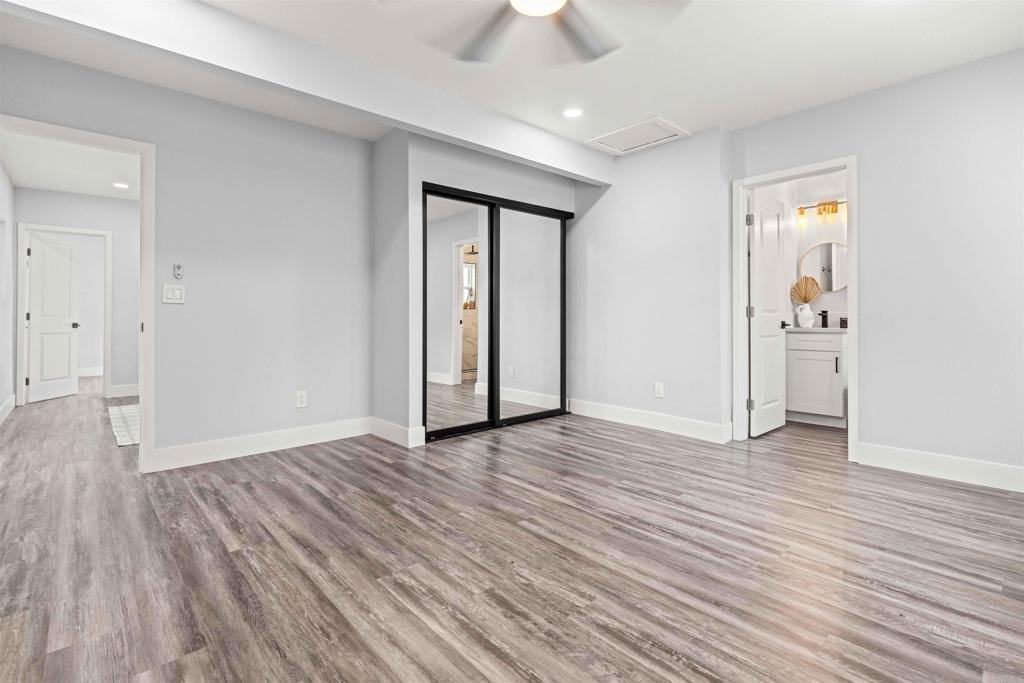 4542 Palm Avenue La Mesa, CA 91941 - Photo 30 of 55 an empty room with wooden floor and a ceiling fan