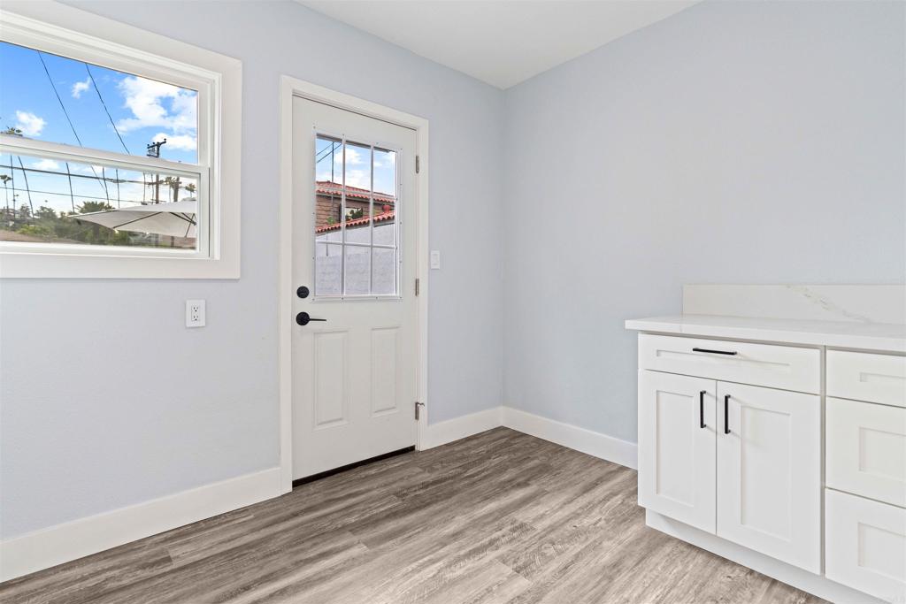 4542 Palm Avenue La Mesa, CA 91941 - Photo 38 of 55 an empty room with wooden floor and windows
