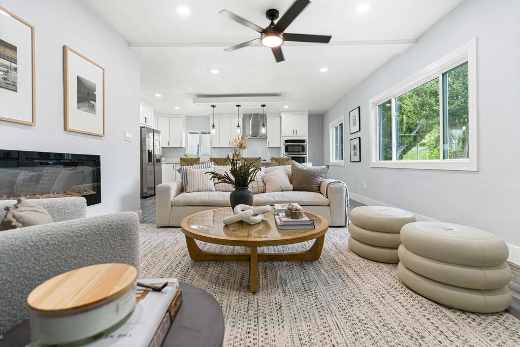 4542 Palm Avenue La Mesa, CA 91941 - Photo 6 of 55 a living room with furniture a chandelier and a fireplace