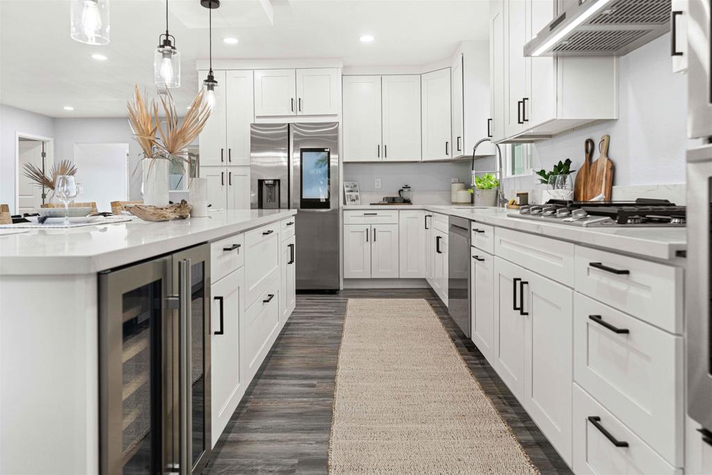 4542 Palm Avenue La Mesa, CA 91941 - Photo 9 of 55 a kitchen with kitchen island granite countertop a sink a counter top space stainless steel appliances and cabinets