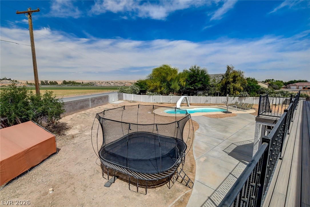 4362 Thistle Street Logandale, NV 89021 - Photo 70 of 99 A spacious backyard awaits, featuring a refreshing in-ground pool and ample deck space.