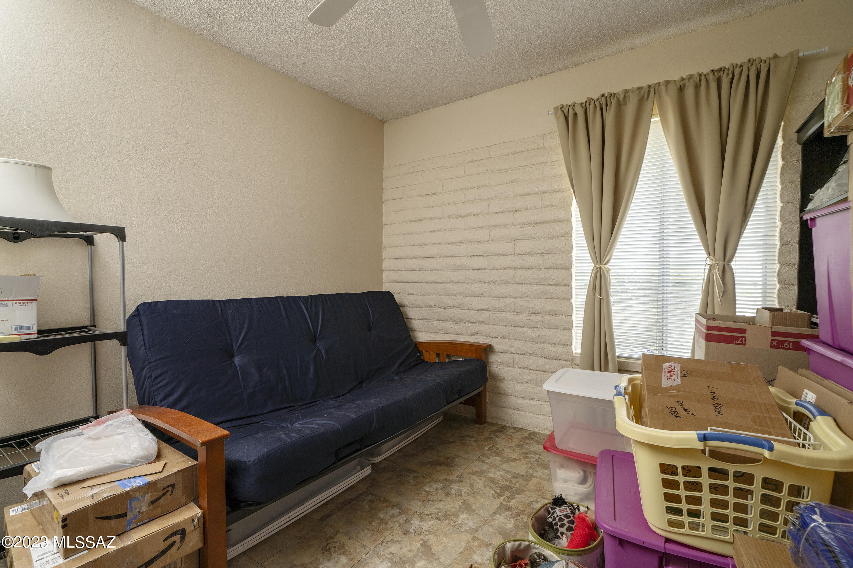 670 South Pantano Road, Unit E Tucson, AZ 85710 - Photo 13 of 17 a living room with furniture and a window