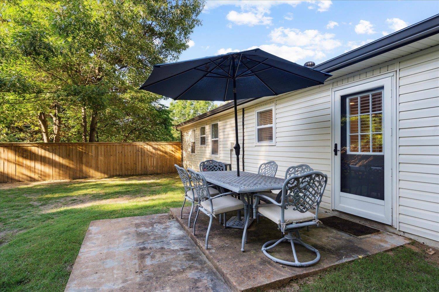 834 Greencliff Road Collierville, TN 38017 - Photo 14 of 20 a patio with a table and chairs under an umbrella