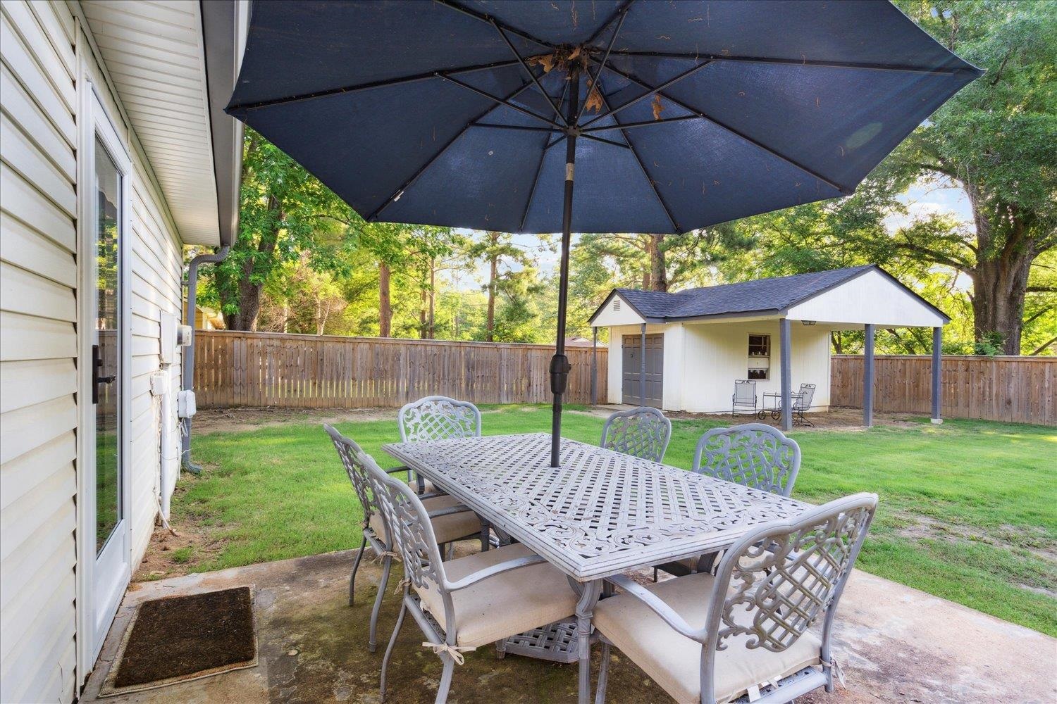 834 Greencliff Road Collierville, TN 38017 - Photo 15 of 20 a view of a table and chairs under an umbrella