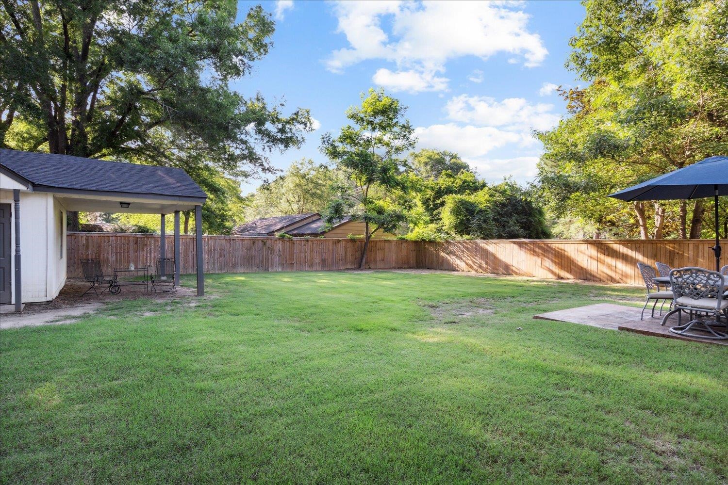 834 Greencliff Road Collierville, TN 38017 - Photo 16 of 20 a view of backyard with table and chairs and a large tree