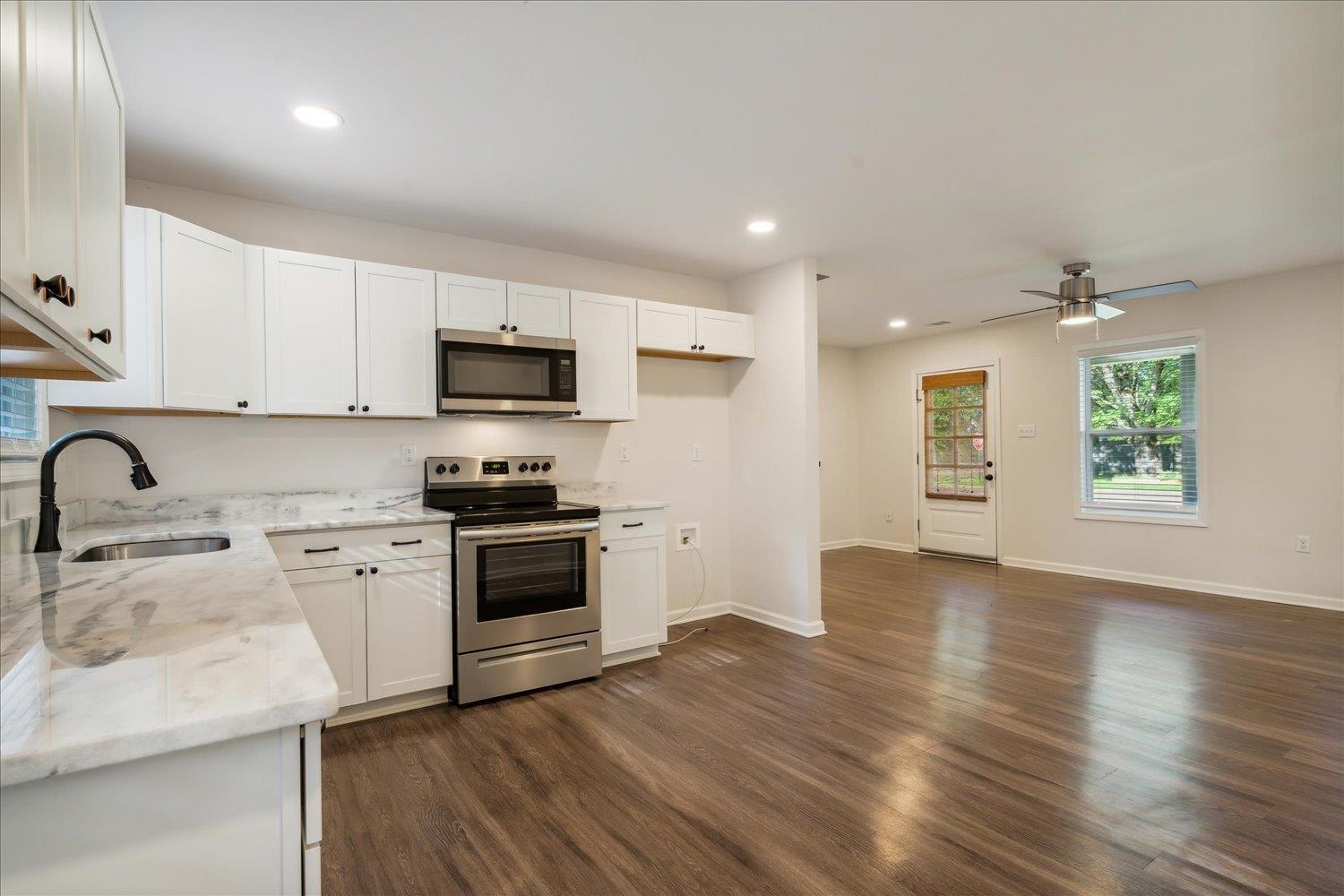 834 Greencliff Road Collierville, TN 38017 - Photo 6 of 20 a kitchen with granite countertop white cabinets and stainless steel appliances
