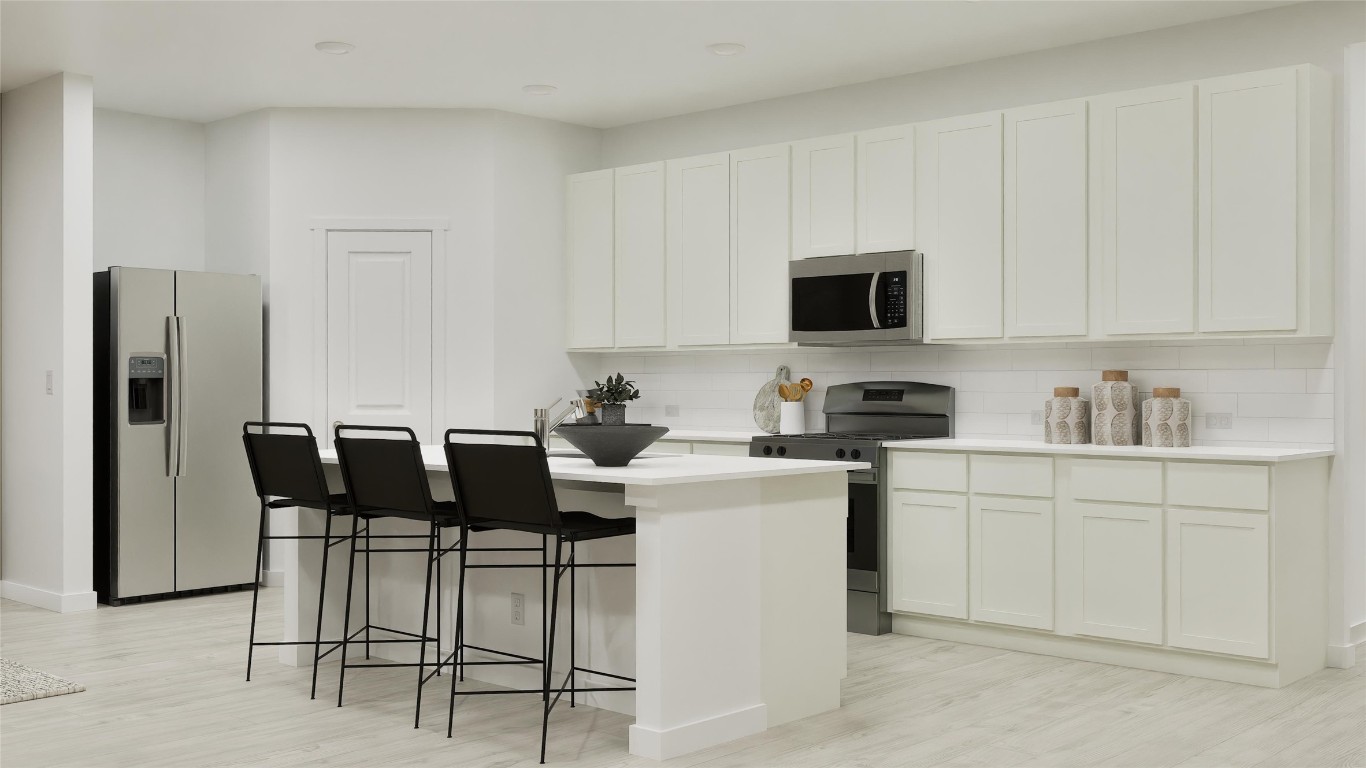 1283 Flint Rdg Loop Salado, TX 76571 - Photo 18 of 34 a kitchen with stainless steel appliances kitchen island granite countertop a table and chairs