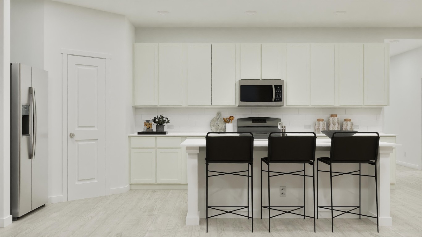 1283 Flint Rdg Loop Salado, TX 76571 - Photo 20 of 34 a kitchen with a stove and white cabinets
