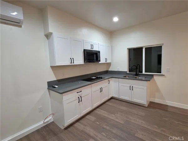 a kitchen with granite countertop a stove and a sink