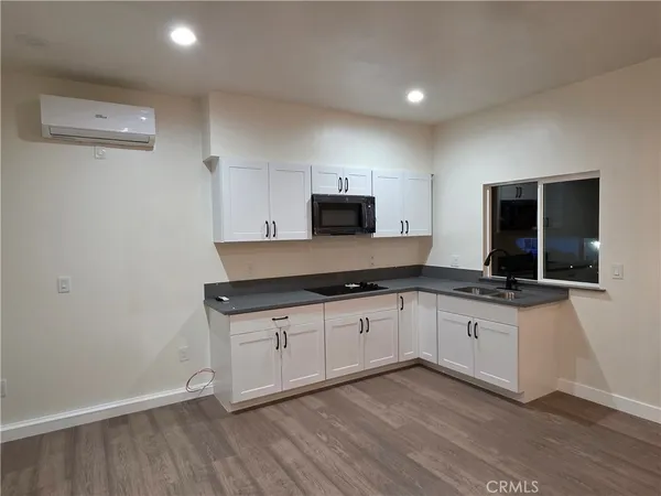 a kitchen with granite countertop a sink and a stove top oven