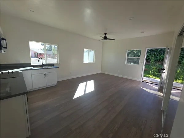 a kitchen with a wooden floor and a window