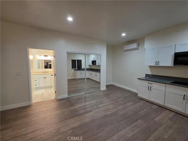a kitchen with granite countertop a stove and a refrigerator