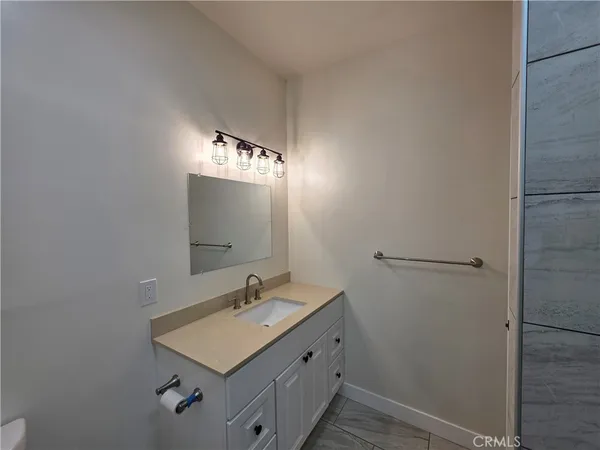 a bathroom with a sink a mirror and vanity