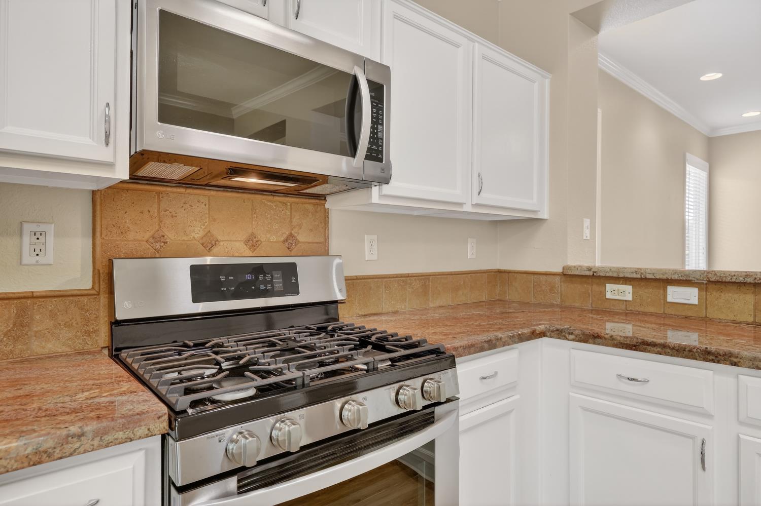 2272 Winding Way Lincoln, CA 95648 - Photo 11 of 46 a kitchen with granite countertop a stove and a microwave