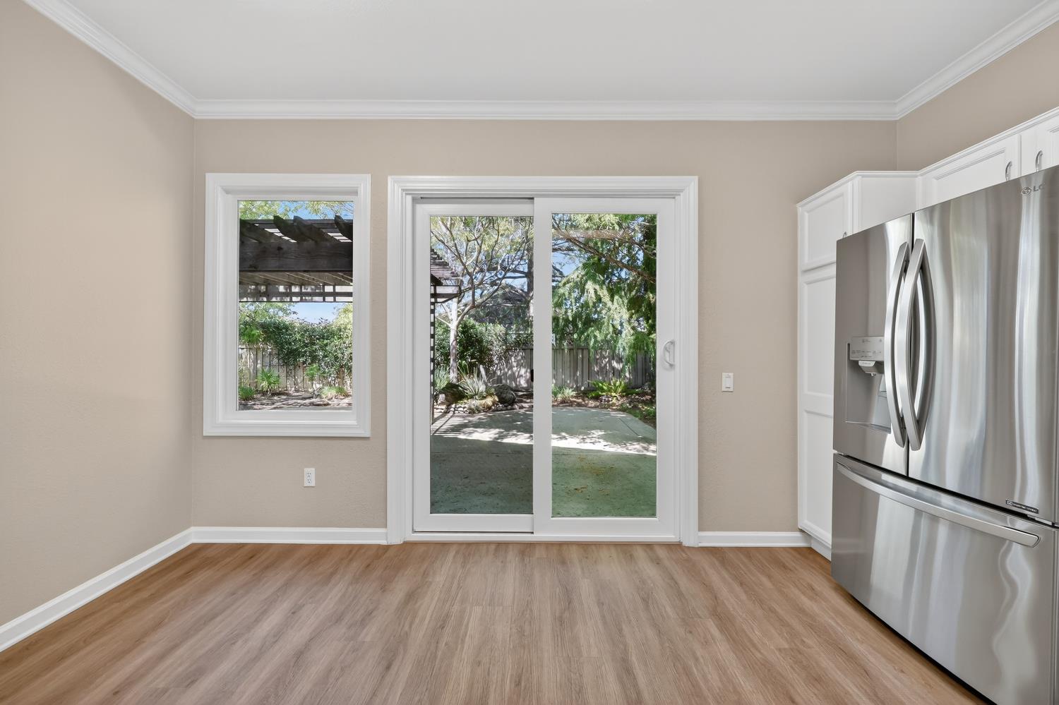 2272 Winding Way Lincoln, CA 95648 - Photo 12 of 46 a view of an empty room with wooden floor and a window