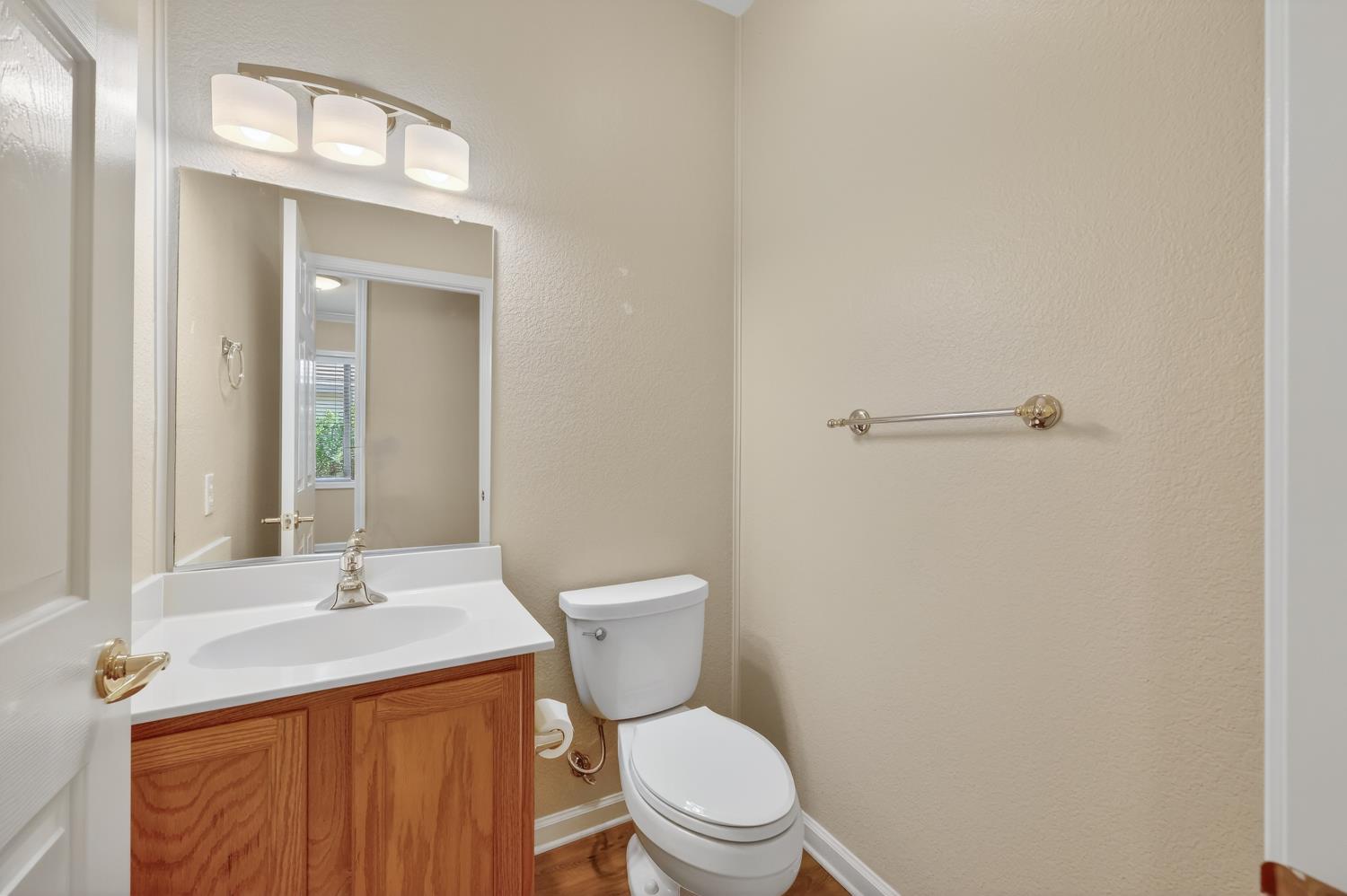 2272 Winding Way Lincoln, CA 95648 - Photo 17 of 46 a bathroom with a granite countertop toilet a sink and a mirror