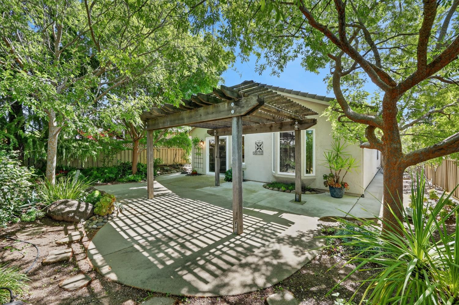 2272 Winding Way Lincoln, CA 95648 - Photo 26 of 46 a view of a backyard with a garden and trees
