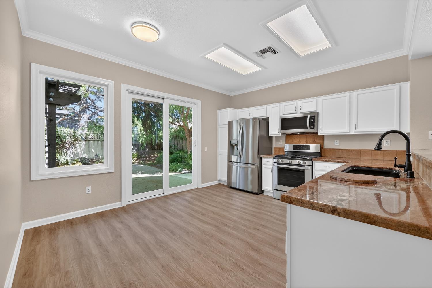 2272 Winding Way Lincoln, CA 95648 - Photo 8 of 46 a kitchen with stainless steel appliances granite countertop a stove top oven a sink with granite countertops and cabinets